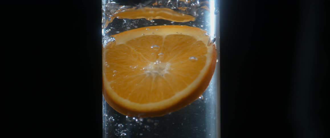 An orange slice in a glass of water