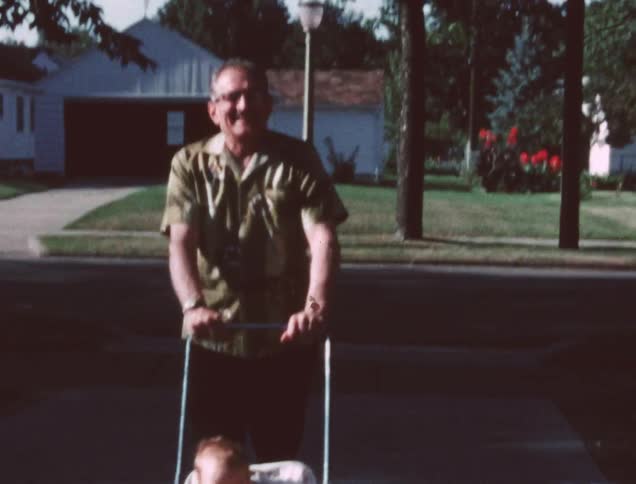 A man pushes a young child in a stroller