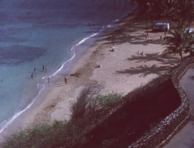 An older film of people playing in the ocean