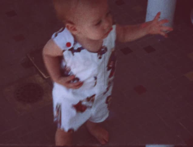 An older film of a child walking around outside