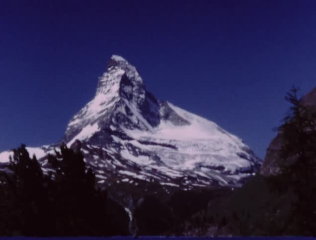 A snow covered mountain peak stands in the distance