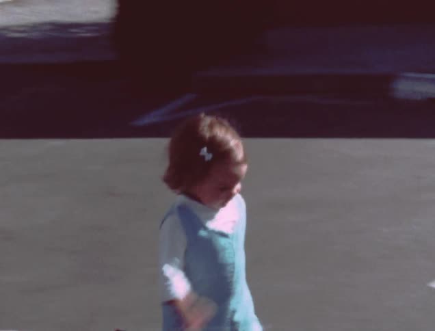 Man holding toddler girl before she happily runs off