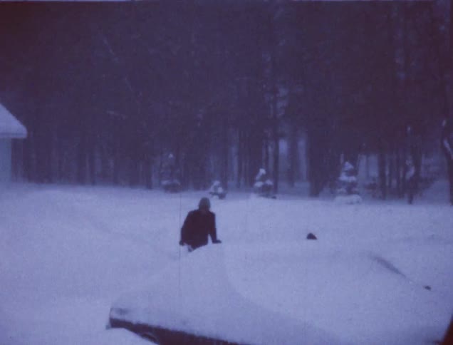 A person uses a snow blower in deep snow