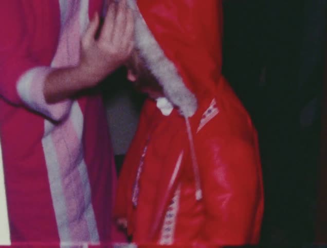 Woman helping little girl put her jacket on
