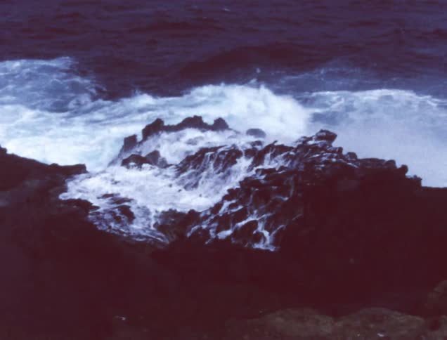 Waves crash into rocks in a river