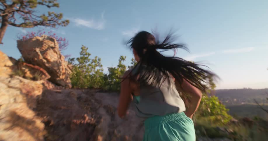 The woman races up the mountain trail
