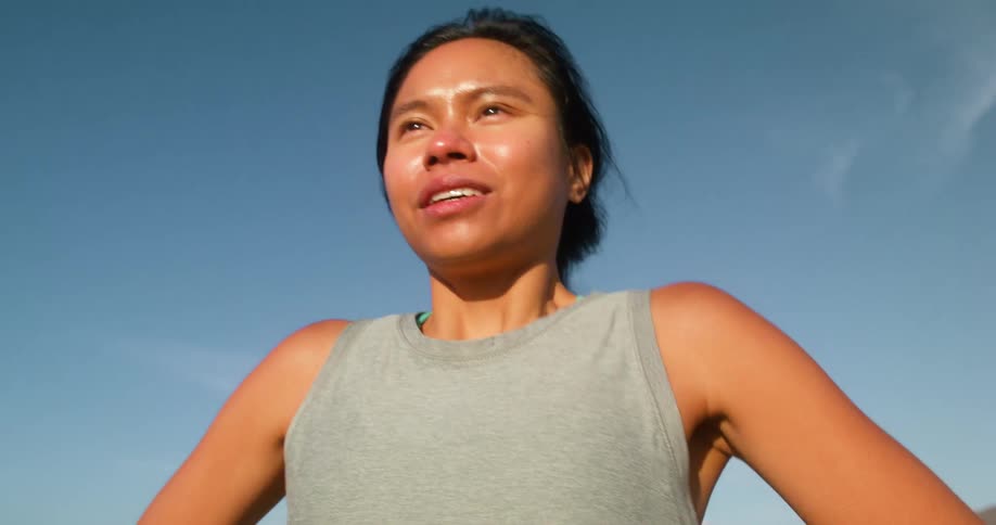 A woman takes deep breaths as the wind hits her face