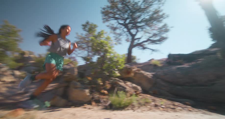 A woman races down the mountain trail