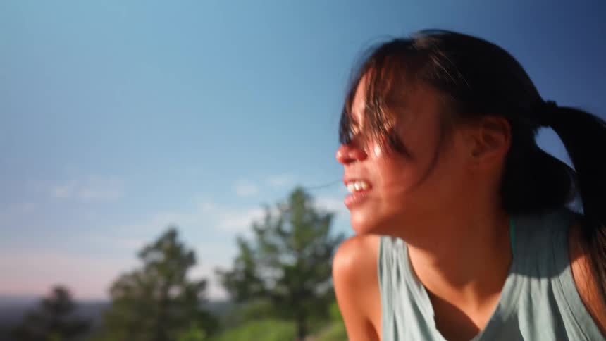 Woman on a mountain breathing a tired world