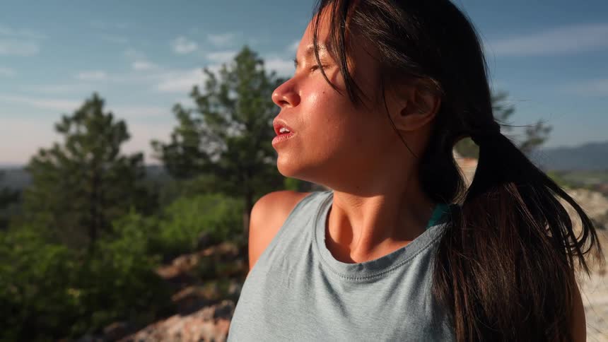 The woman is breathing heavily under the sun