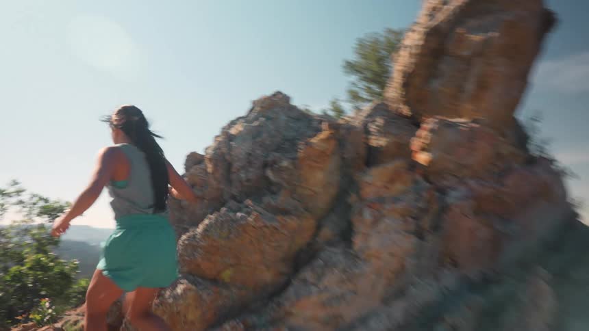 Woman running on a mountain trail