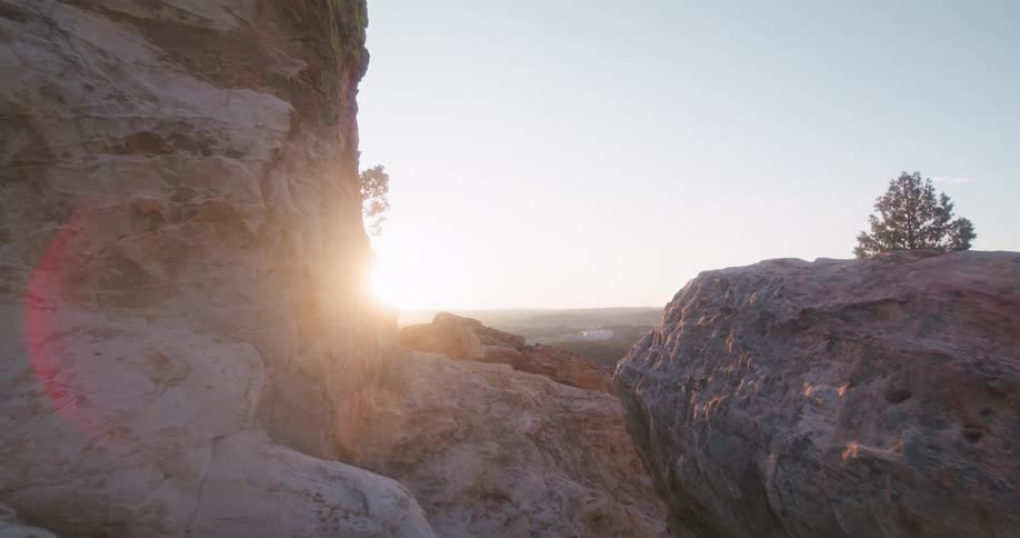 A scenic view of rocky cliffs at sunset overlooking a distant landscape
