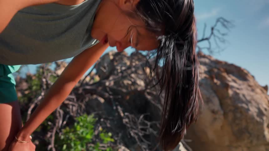 Woman outdoors taking deep breath tired
