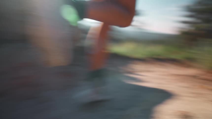 Woman running on a trail in the mountains during the day
