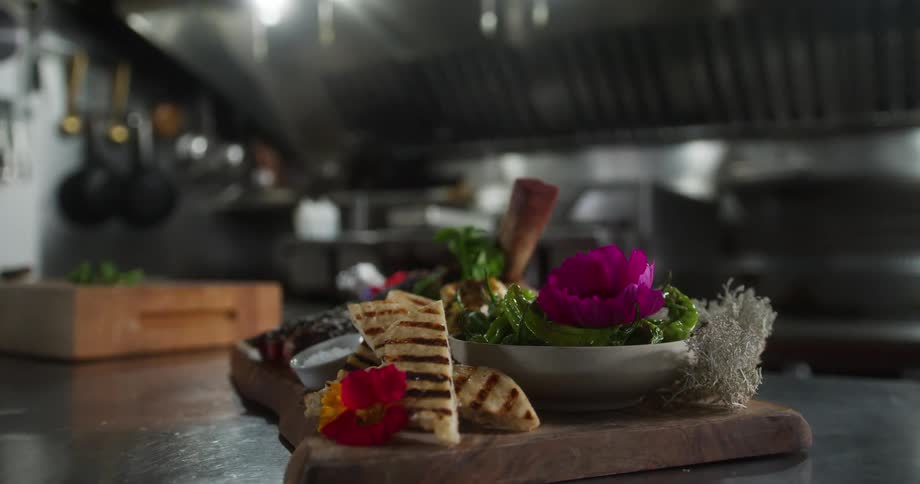 A large dish is on display in the restaurant kitchen