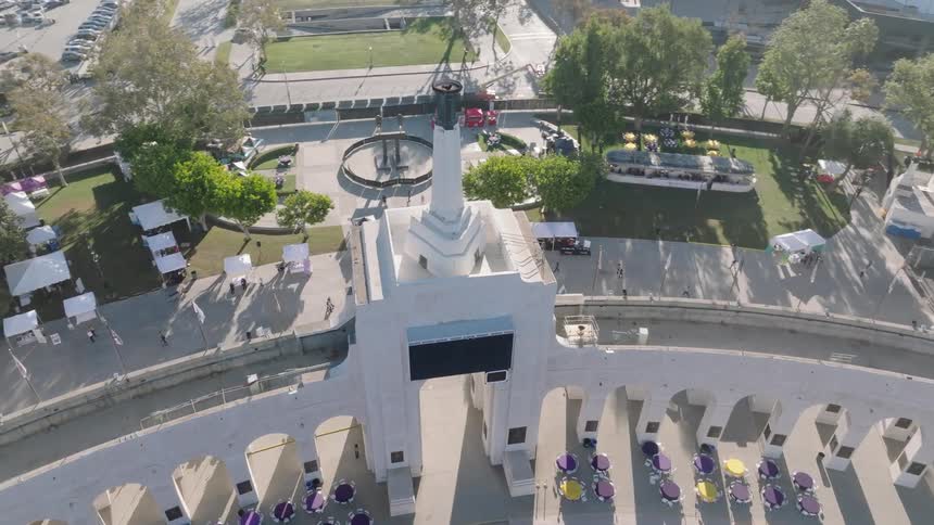 Aerial view of classical architecture with the Olympic torch in front of a square at Los Angeles Memorial Coliseum