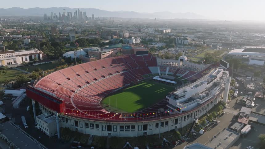 Aerial of am empty soccer stadium in a city during daytime