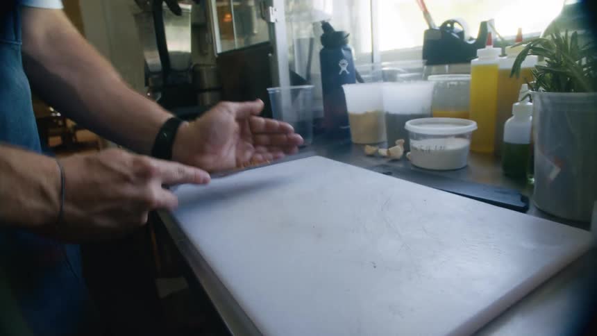 Pair of hands with a knife picking up spices
