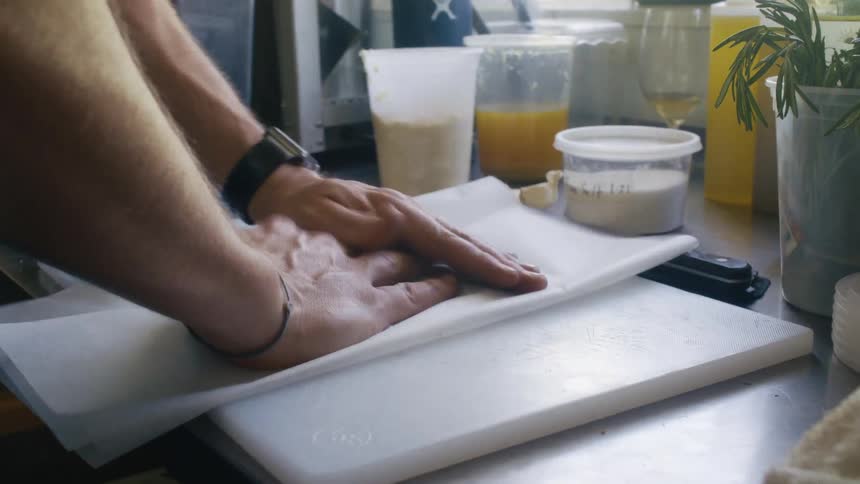 Pair of hands rolling up parchment paper