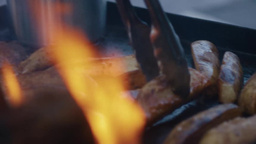 Spatula roasting potatoes on a griddle