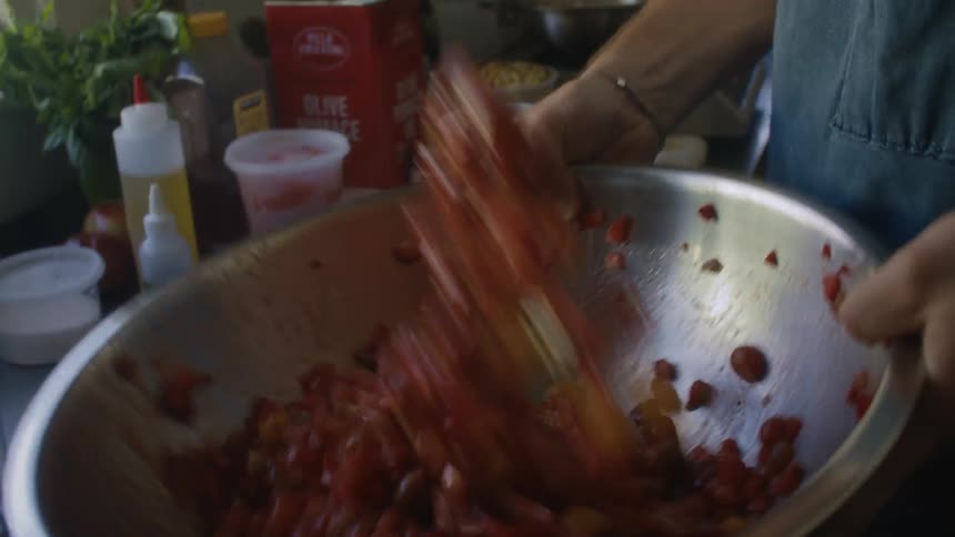The chef tosses ingredients in a bowl and tosses it around