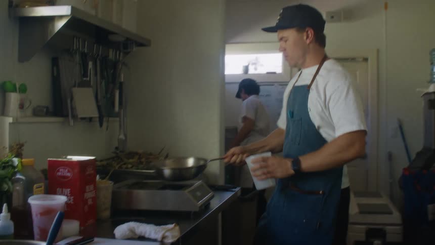 The man drains the pan into a container