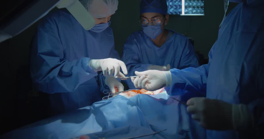 Medical team with equipment performing surgery on a patient