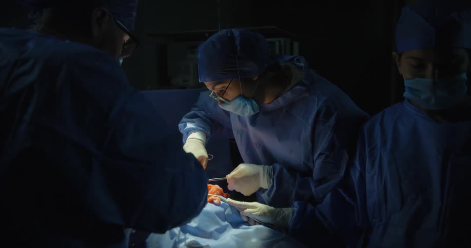 A patient is being operated on by medical professionals in an operating room