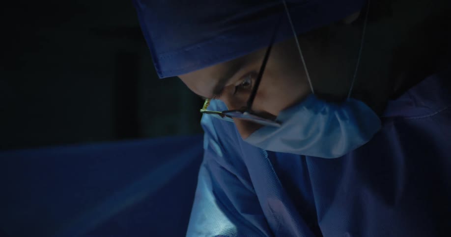 Surgeons perform a surgery on a patient in an operation theatre