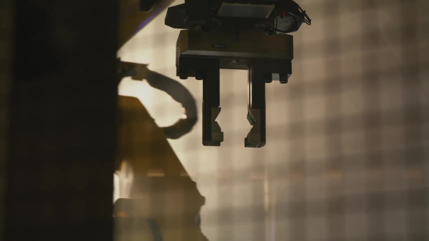 Mechanical arm of a robot in operation in a factory
