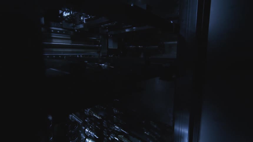 Rows of metal components lined up in a dark structure