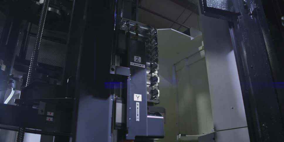 Industrial cnc machining equipment with large metal part being worked vertically