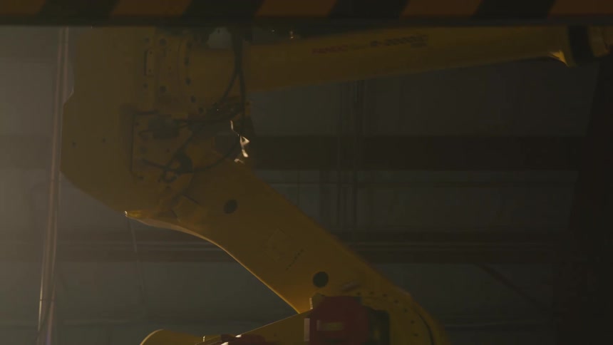 Mechanical and industrial arm in operation in a factory