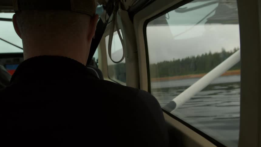 Man inside a water plane that is on the surface of an ocean