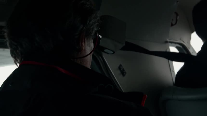 A man is sitting in the back of the plane