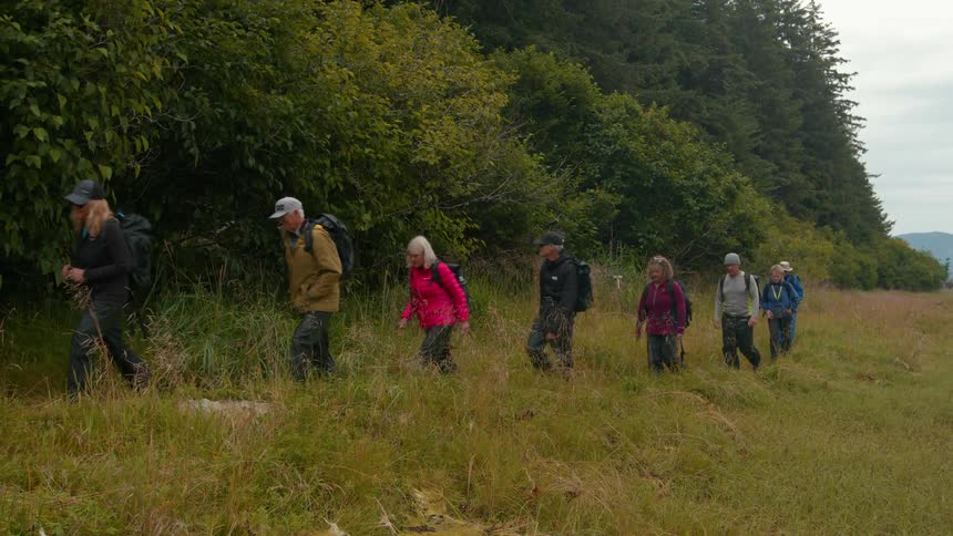 Group of hikers walking in a line in a natural environment
