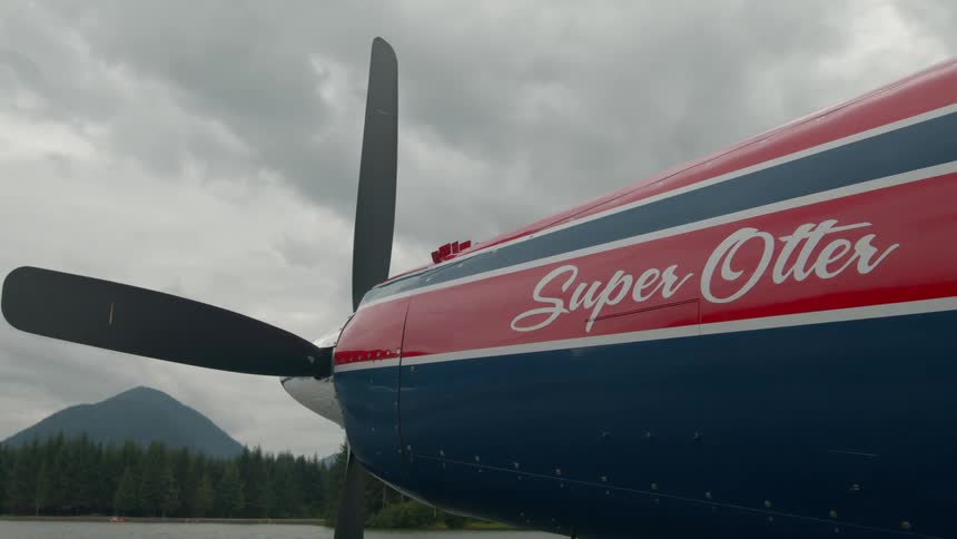 A seaplane parked on a lake has super otter written on it
