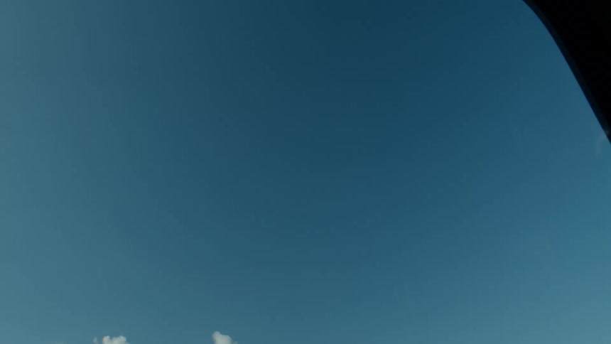 Upward view of a moving propeller against a blue sky