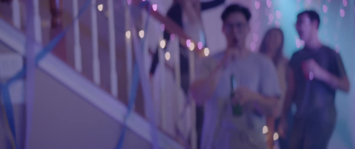 A man with sunglasses break dances at a party