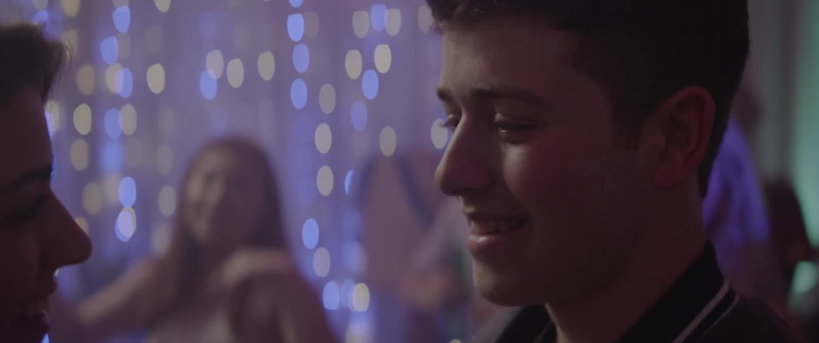 People are dancing in a party with flashing lights all over