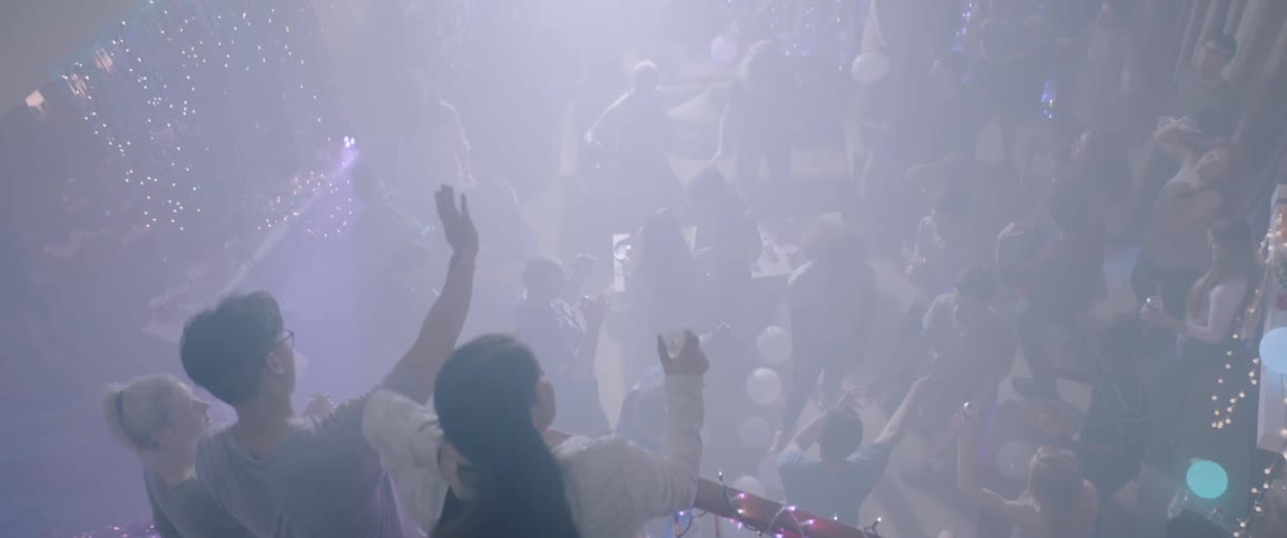 People are partying below throwing balloons