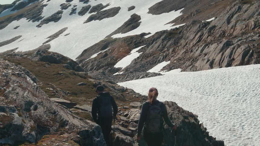 Man and woman hiking on a snowy mountain