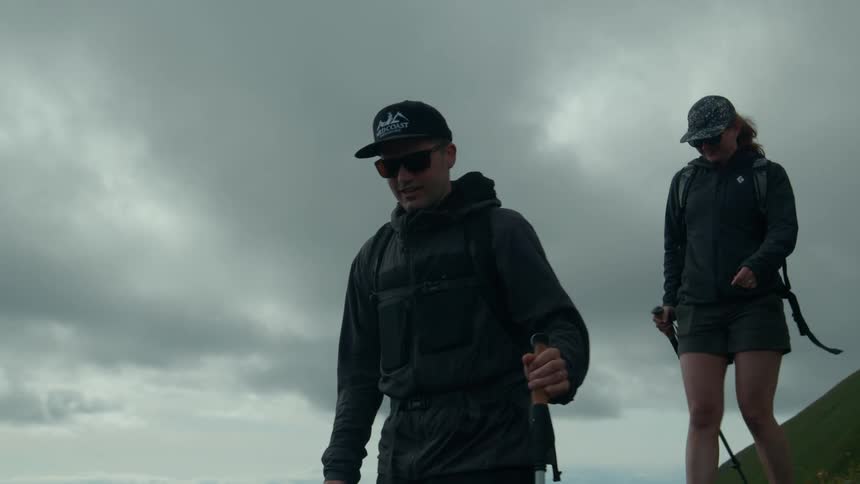 Man and woman hiking on a cloudy day