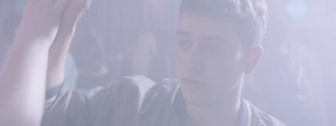 A boy walks through a busy party