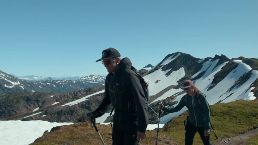 Woman and a man hiking on a snowy mountain