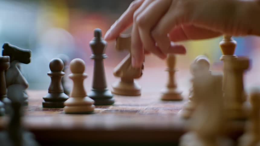 A chess piece is knocked over midgame as another piece is captured in a dynamic move