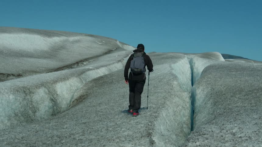 Person climbing an ice wall on a mountain