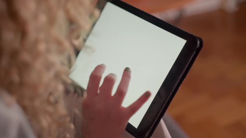 Child interacting with a tablet