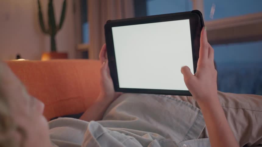 Woman in a room interacting with a tablet