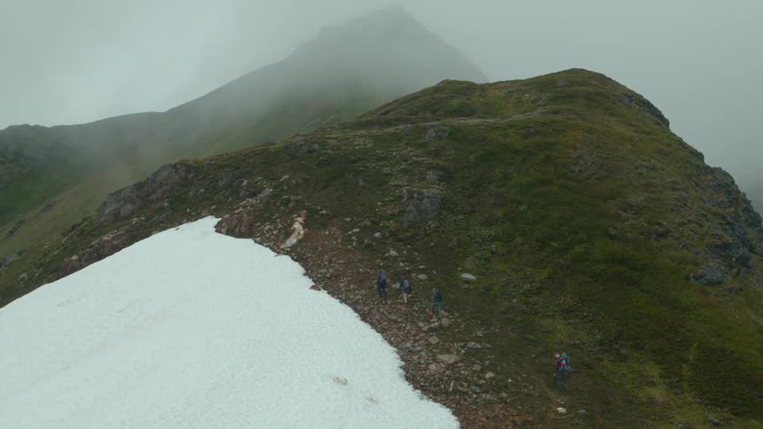 Group of hikers walking through the mountains